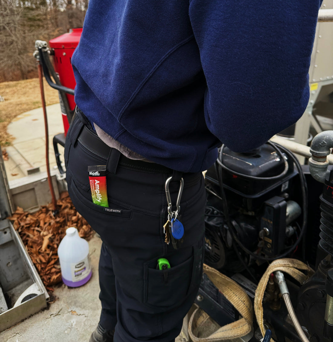 Worker on a job site with an Amplify electrolyte stick in his back pocket