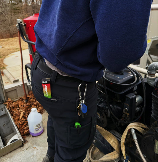 Worker on a job site with an Amplify electrolyte stick in his back pocket